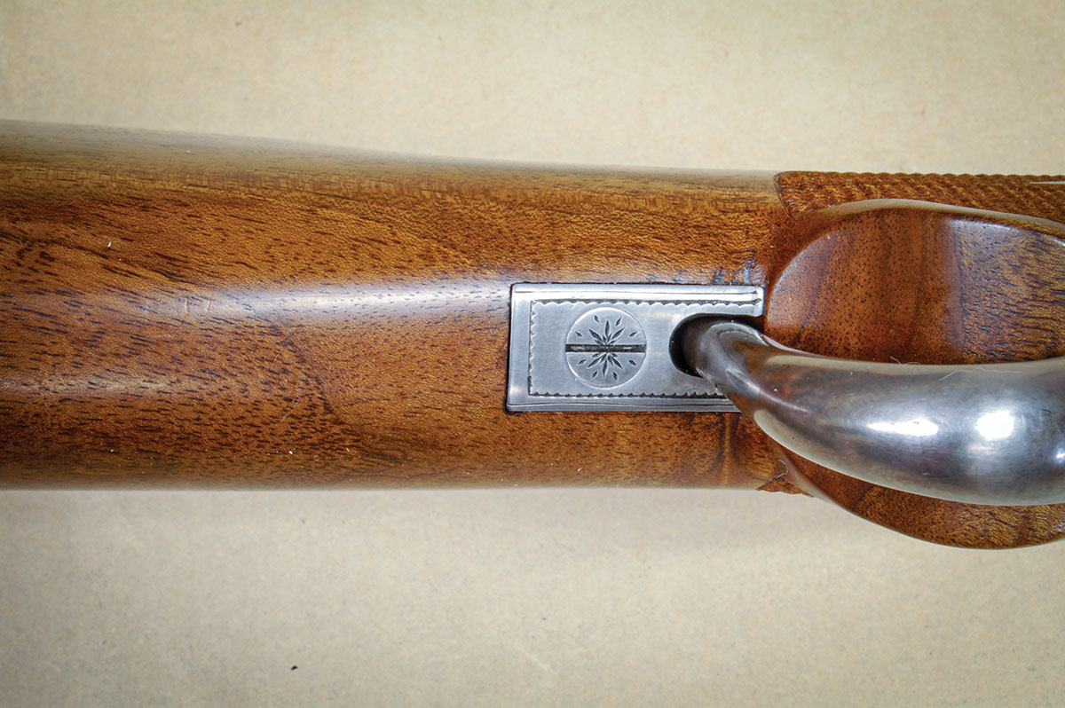 A piece of steel behind the pistol grip holds the lever up by friction alone. A mechanical latch is not needed.